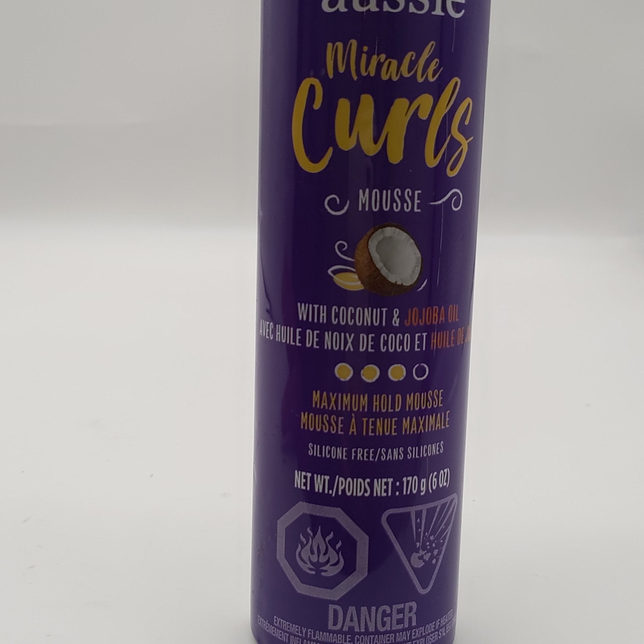 A 6 oz bottle of Aussie Miracle Curls Mousse designed for curl definition and frizz control.