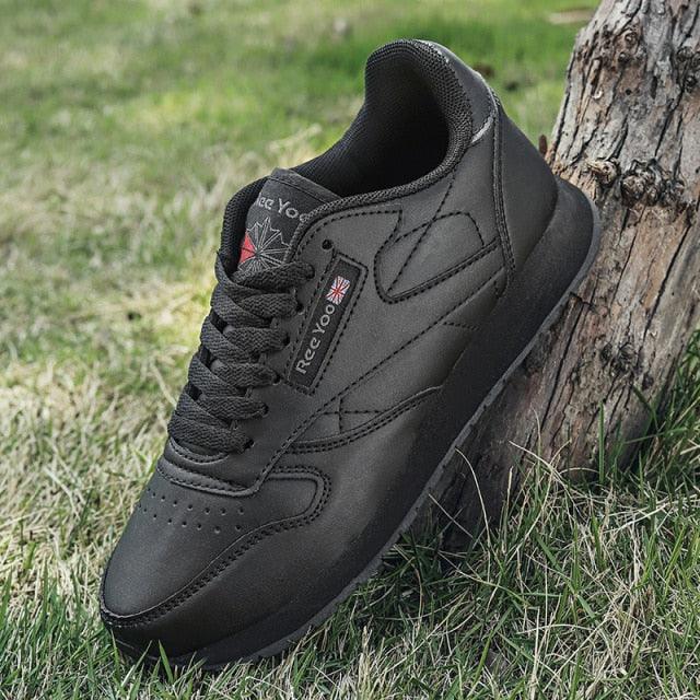 A pair of black vulcanized lace-up fashion sneakers with high-grip rubber outsoles.
