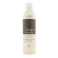 Aveda Damage Remedy Restructuring Shampoo bottle in beige and brown minimalist packaging