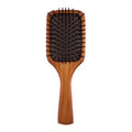 Aveda wooden mini paddle brush with natural wood handle and black bristles, minimalist hair styling tool.
