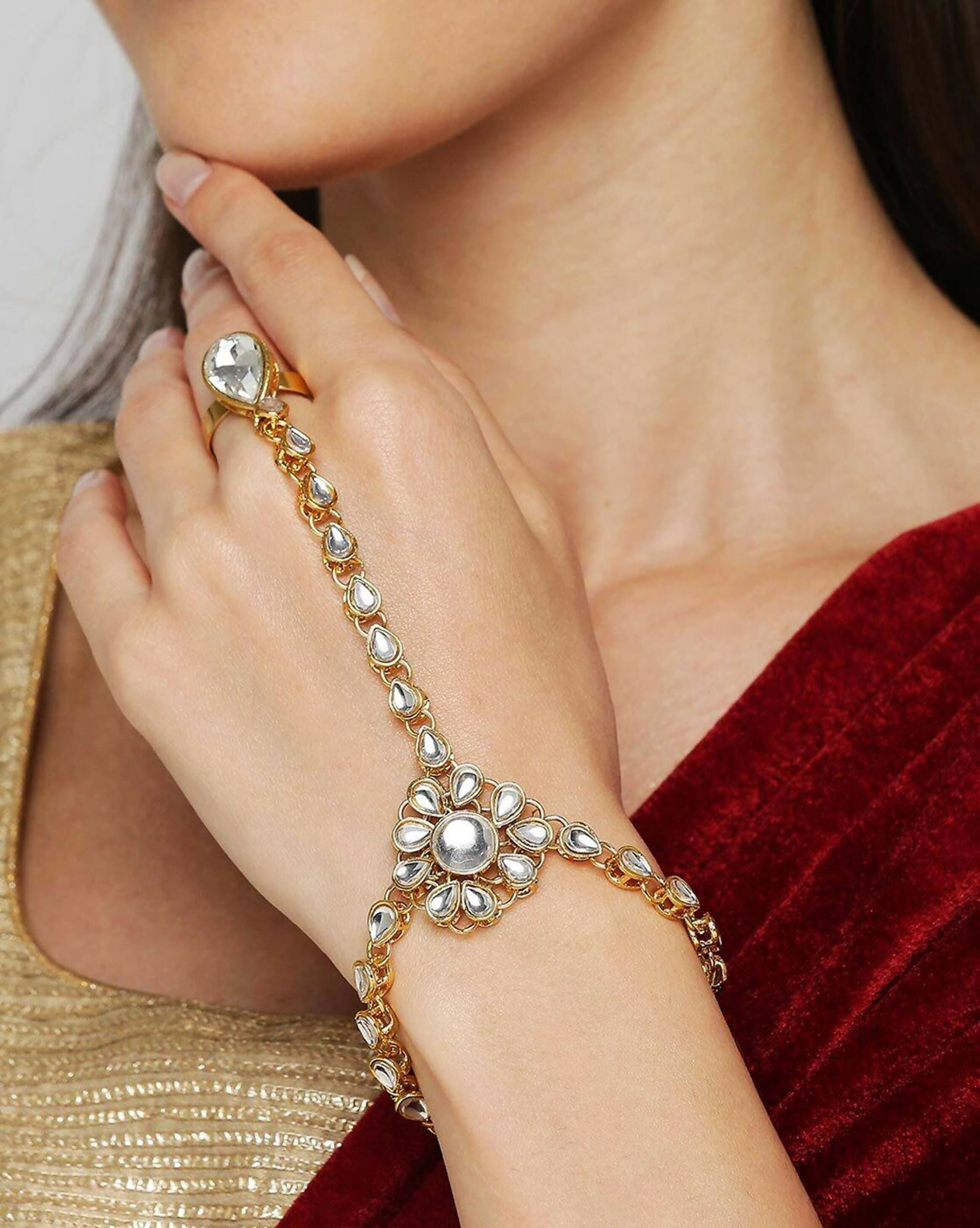 Close up of an elegant white Kundan and pearl chain Hathphool worn on a hand