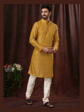 Boy wearing a mustard yellow art silk kurta pyjama with digital print detailing