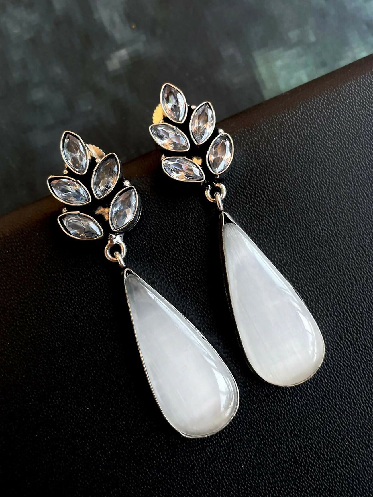 Large white Monalisa stone party earrings in oxidized brass