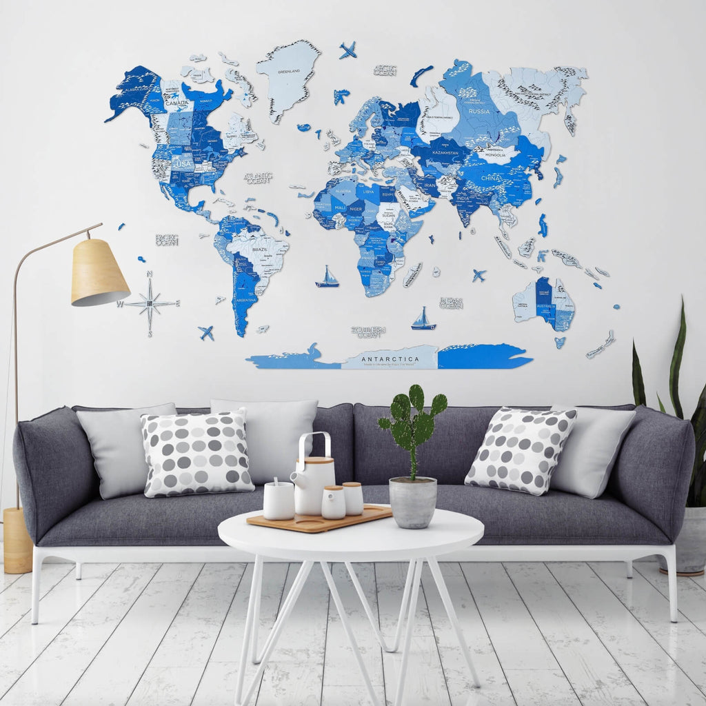 3D wooden world map in shades of blue with geometric layers on a white wall