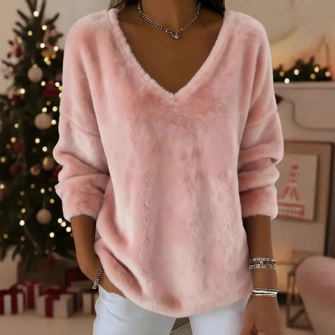 A woman wearing a soft pink plush V-neck pullover sweater with a relaxed drop shoulder fit.