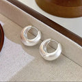 Elegant high-end stud earrings featuring a traditional brushed metal finish.