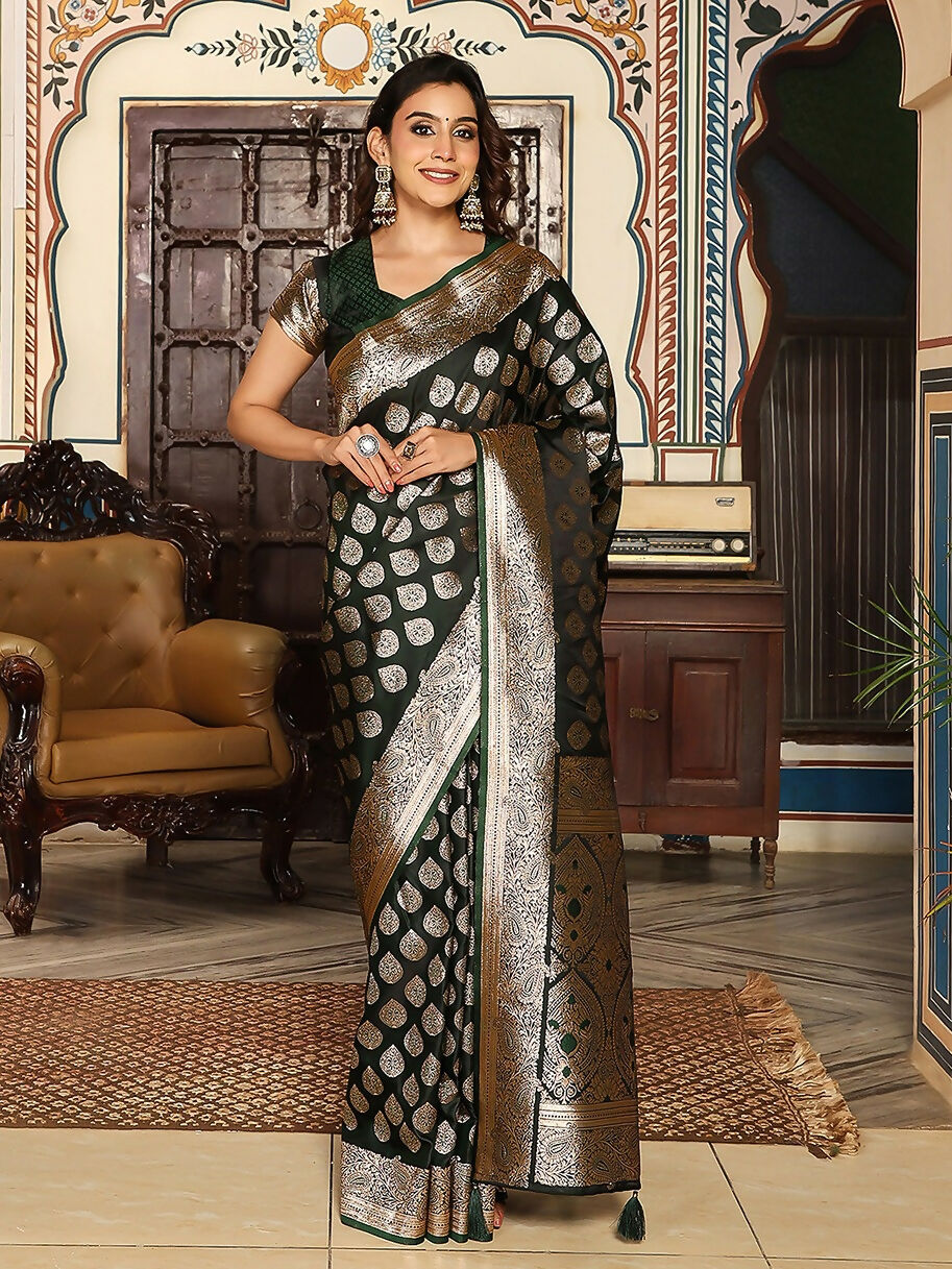 Deep dark green silk saree with matching blouse piece displayed elegantly.