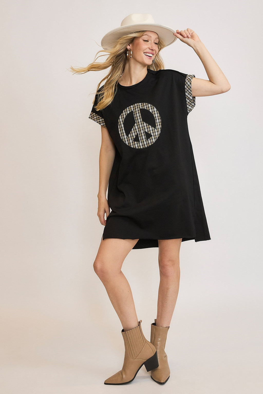 Trendy black and tan plaid mini dress with peace sign applique