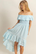 High-low summer dress featuring off-shoulder ruffles and intricate eyelet fabric texture.