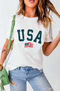 A woman wearing a white short-sleeve t-shirt with a blue distressed USA graphic and a small American flag print on the front.