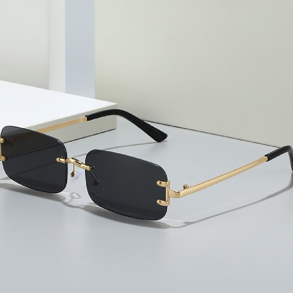 Elegant rimless sunglasses with a gold bridge and gradient lenses.