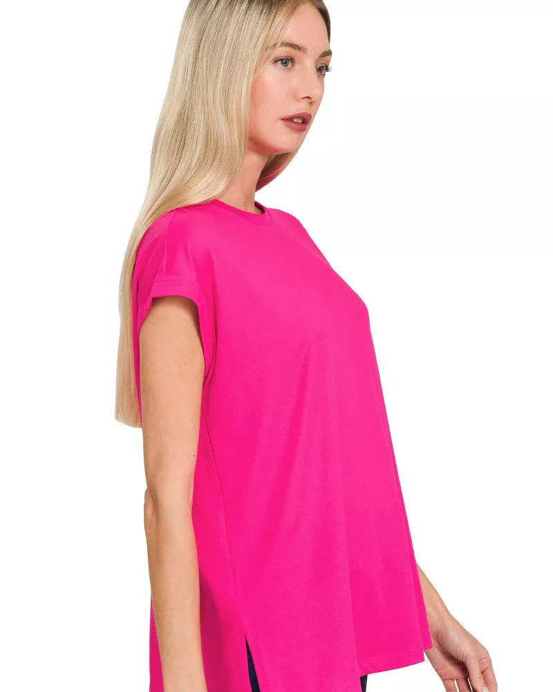 Woman wearing a bright pink t-shirt with a plain background