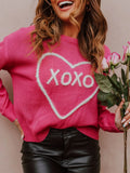 Model wearing a pink drop shoulder sweater with a white heart and XOXO graphic, next to an image of a white sweater with a red heart and XOXO graphic.