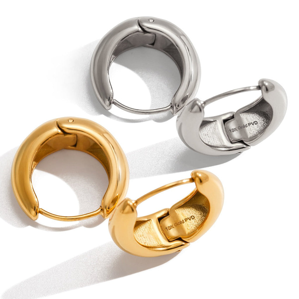 Polished 18K gold hoop earrings showing the internal engraved detail
