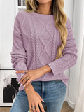 A woman wearing a lavender round neck long sleeve sweater with a cable knit diamond pattern.