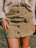 Tan button-front corduroy mini skirt with faux pocket flaps on a hanger