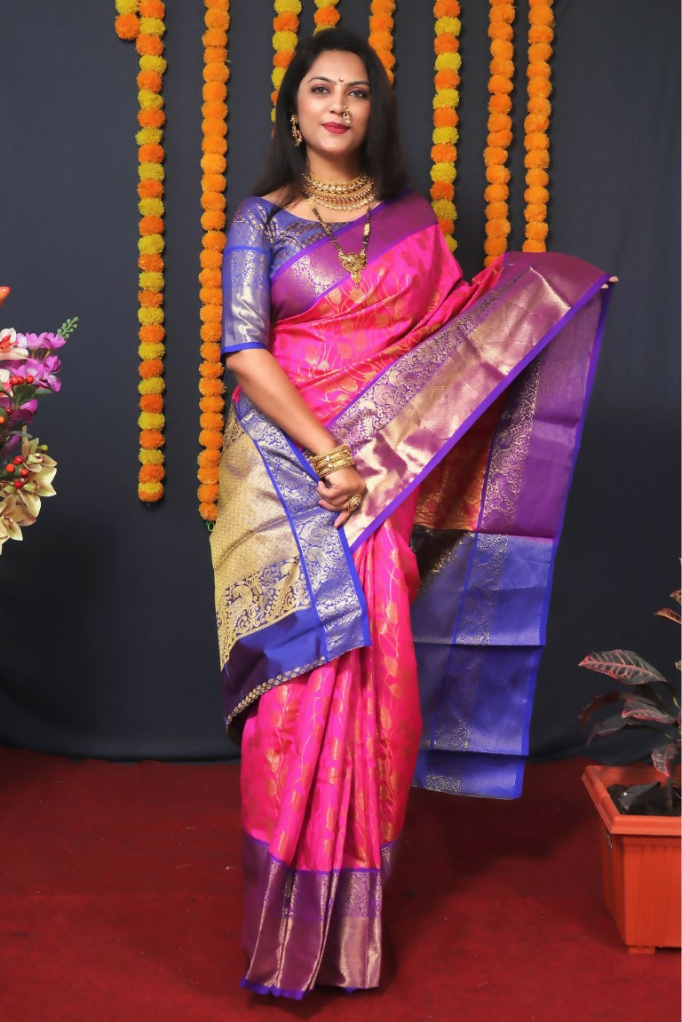 Pink Kanjivaram silk saree with Zari woven pattern and contrast blue blouse