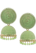 A pair of gold-polished Pista Green Meenakari Jhumkas with pearl detailing on a neutral background.