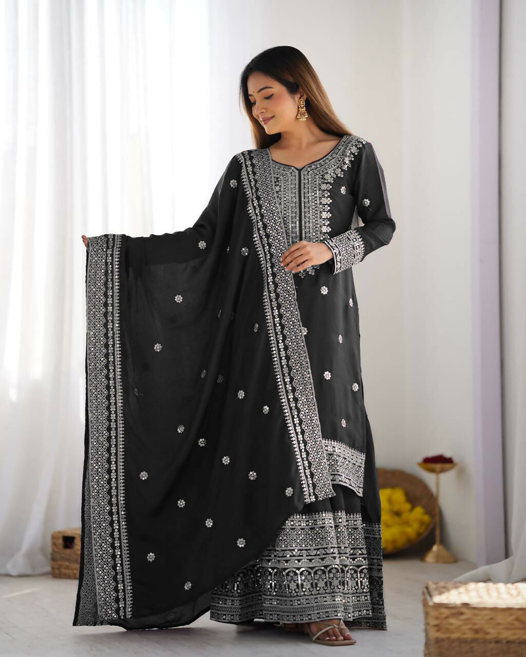 Elegant black silk kurta set with intricate sequins, zari, and thread embroidery for formal wear.