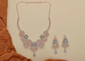 Golden White AD necklace set featuring intricate brass craftsmanship and brilliant stone accents.