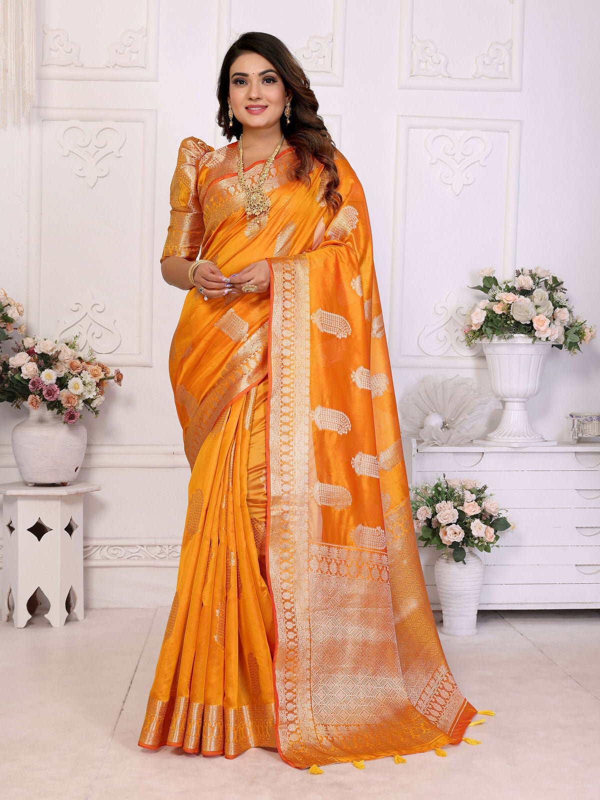 Bright yellow soft organza silk saree with elegant woven detailing and a graceful drape.