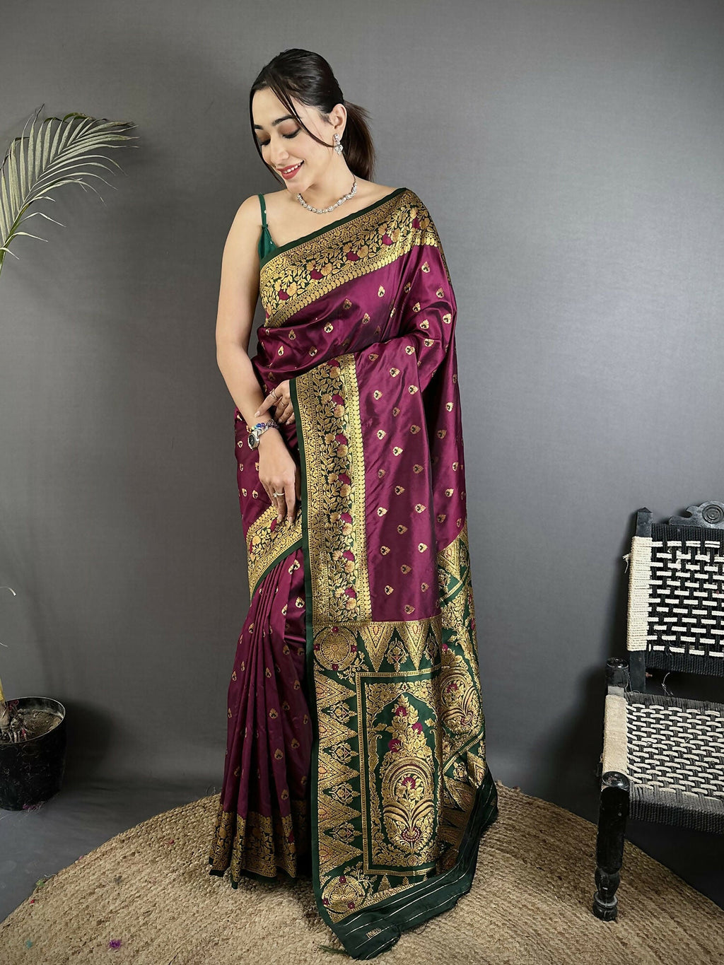 Wine-colored soft silk Banarasi saree featuring intricate motifs with a dark green butti blouse.