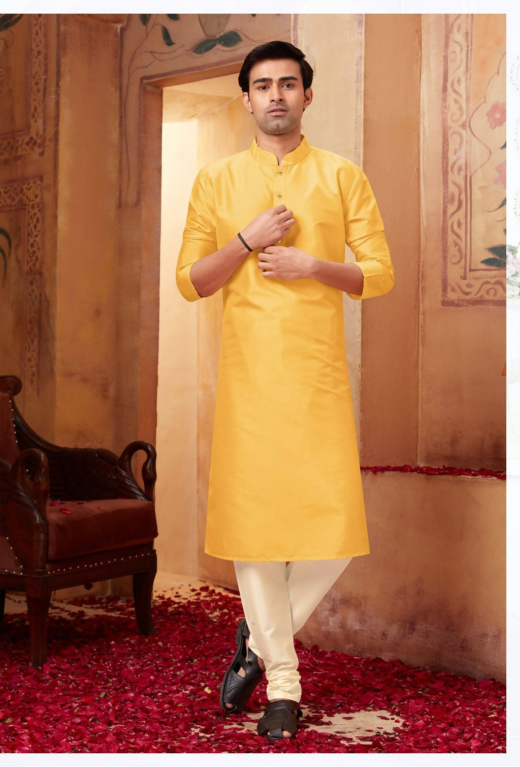Baby boy dressed in a bright yellow art silk kurta paired with off-white pyjama pants