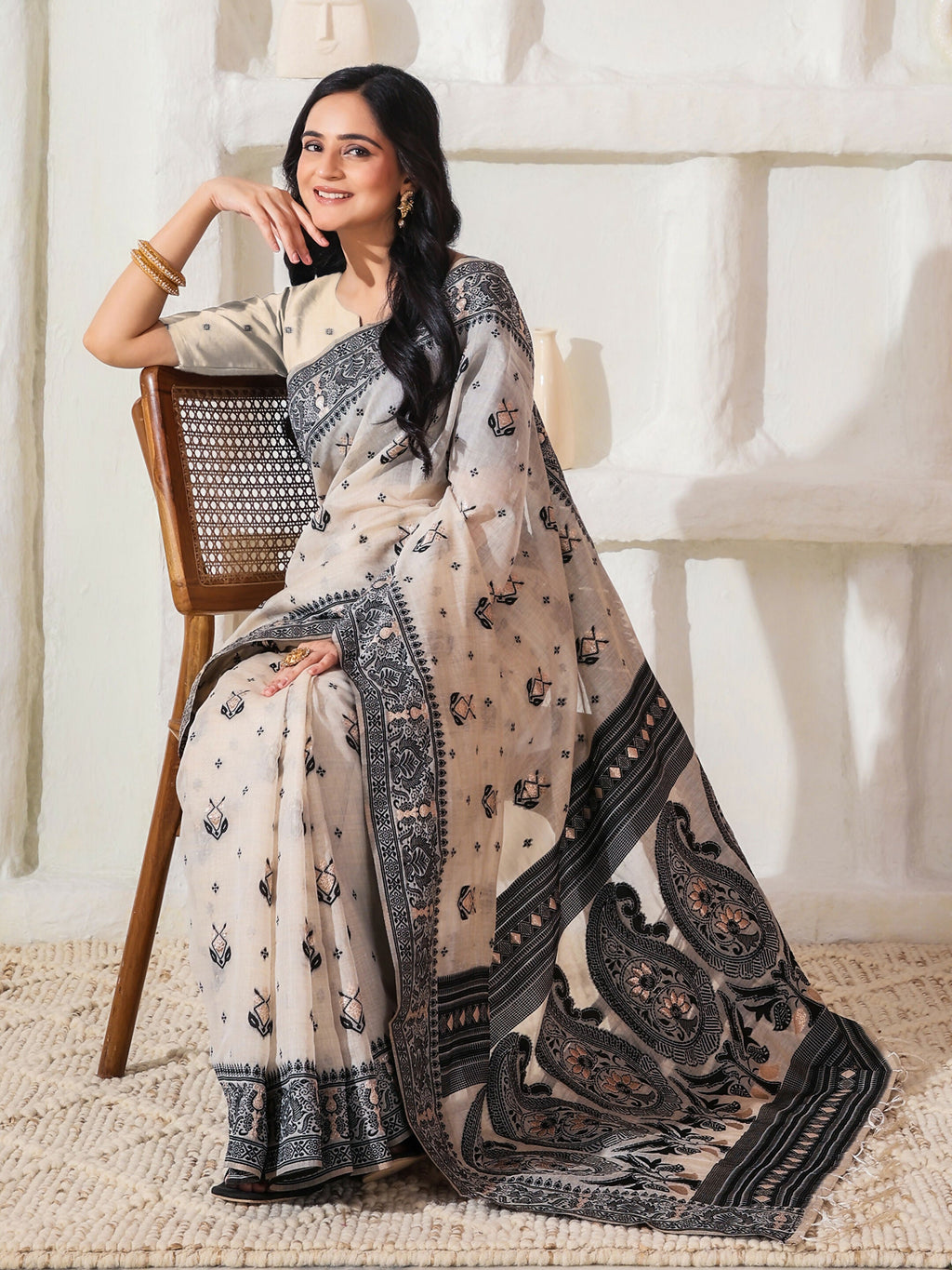 Black and Cream linen cotton saree with matching blouse piece draped elegantly.
