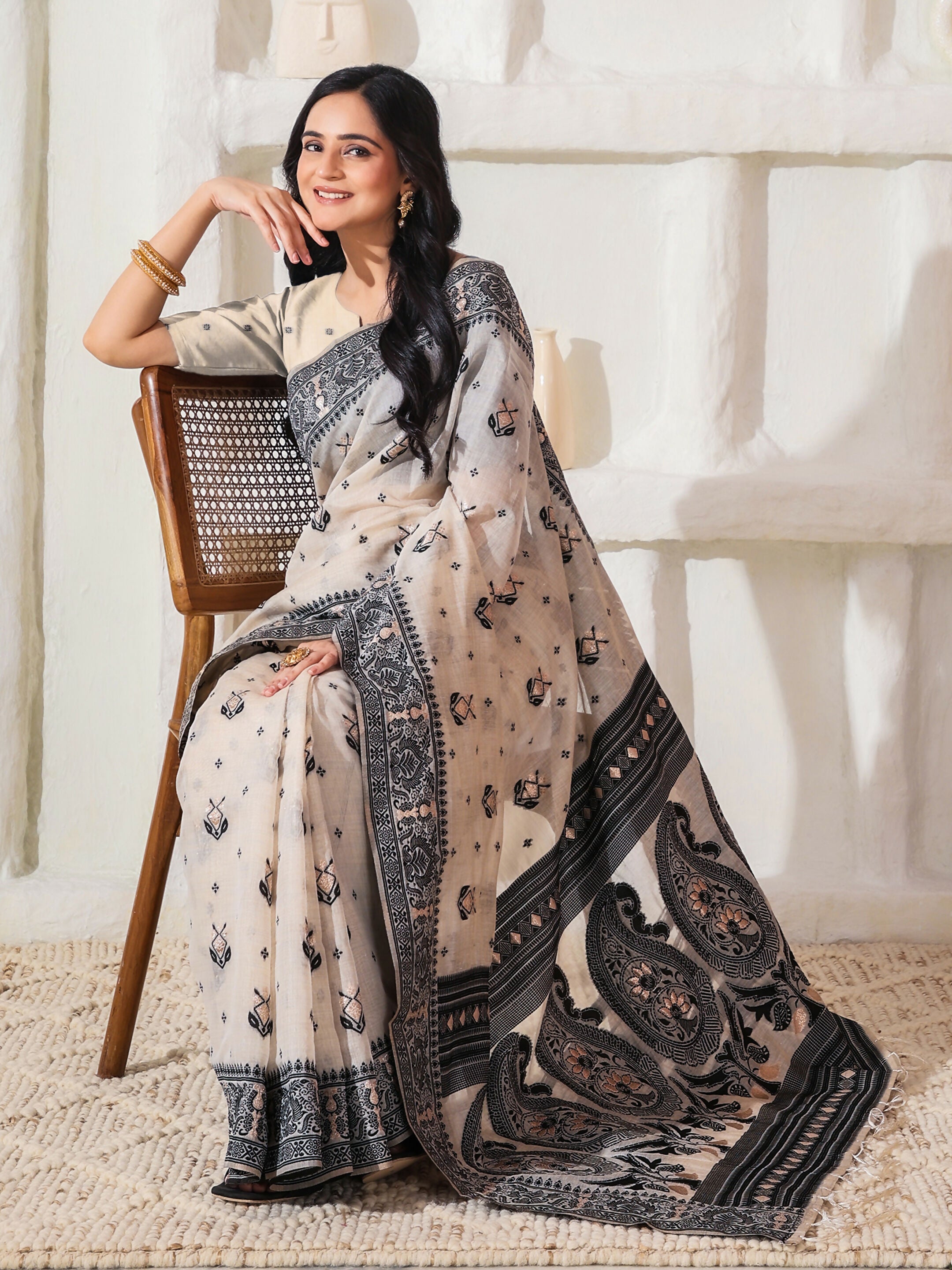 Black and Cream linen cotton saree with matching blouse piece draped elegantly.