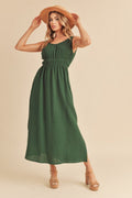 Sleeveless forest green midi dress with a round neck and elegant side slit.