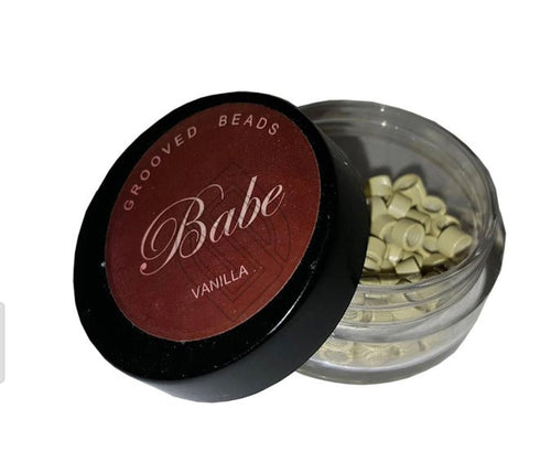 100 pieces of grooved beads in vanilla color stored in a clear container