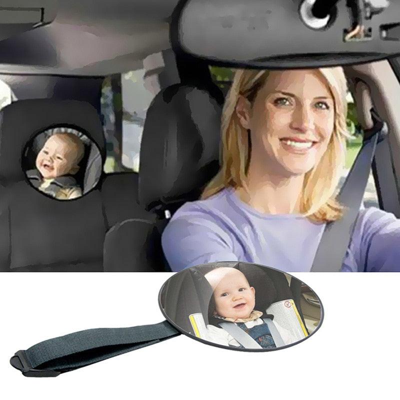 Wide-angle rear-facing baby car mirror mounted for optimal visibility of infants in the back seat.