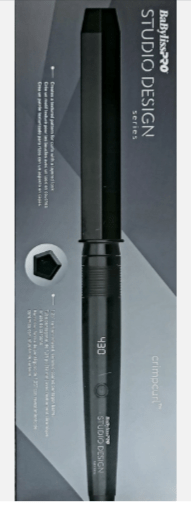 Professional black Studio Design CrimpCurl styling tool with 1/2 inch barrel on a modern bathroom counter