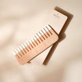 Minimalist wooden hair comb with natural wood finish and white dipped tips