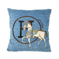 Blue throw pillow cover featuring a horse pattern on a neutral background, styled on a couch.