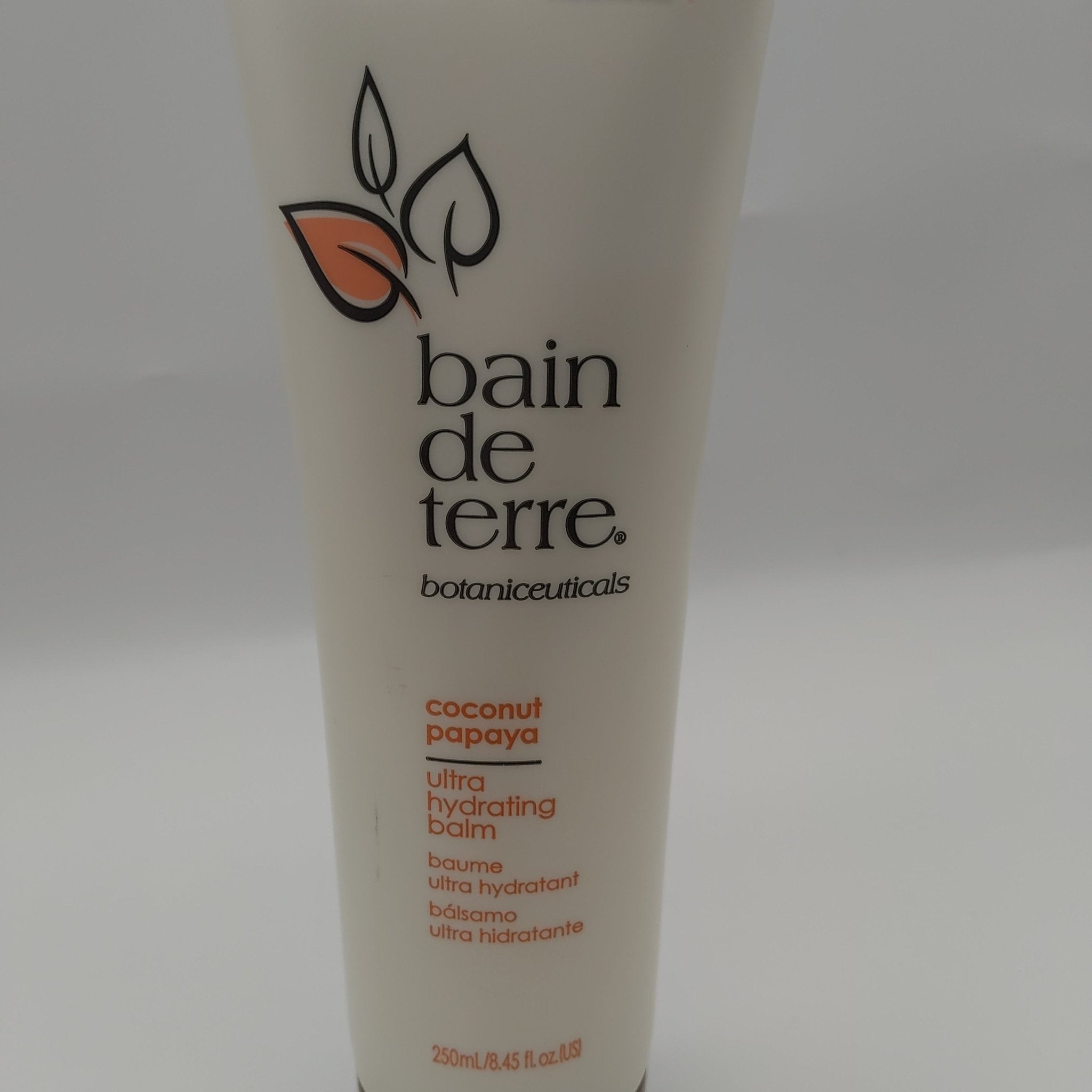 White and orange bottle of Bain de Terre Coconut Papaya Ultra Hydrating Treatment Balm 8.45 fl oz