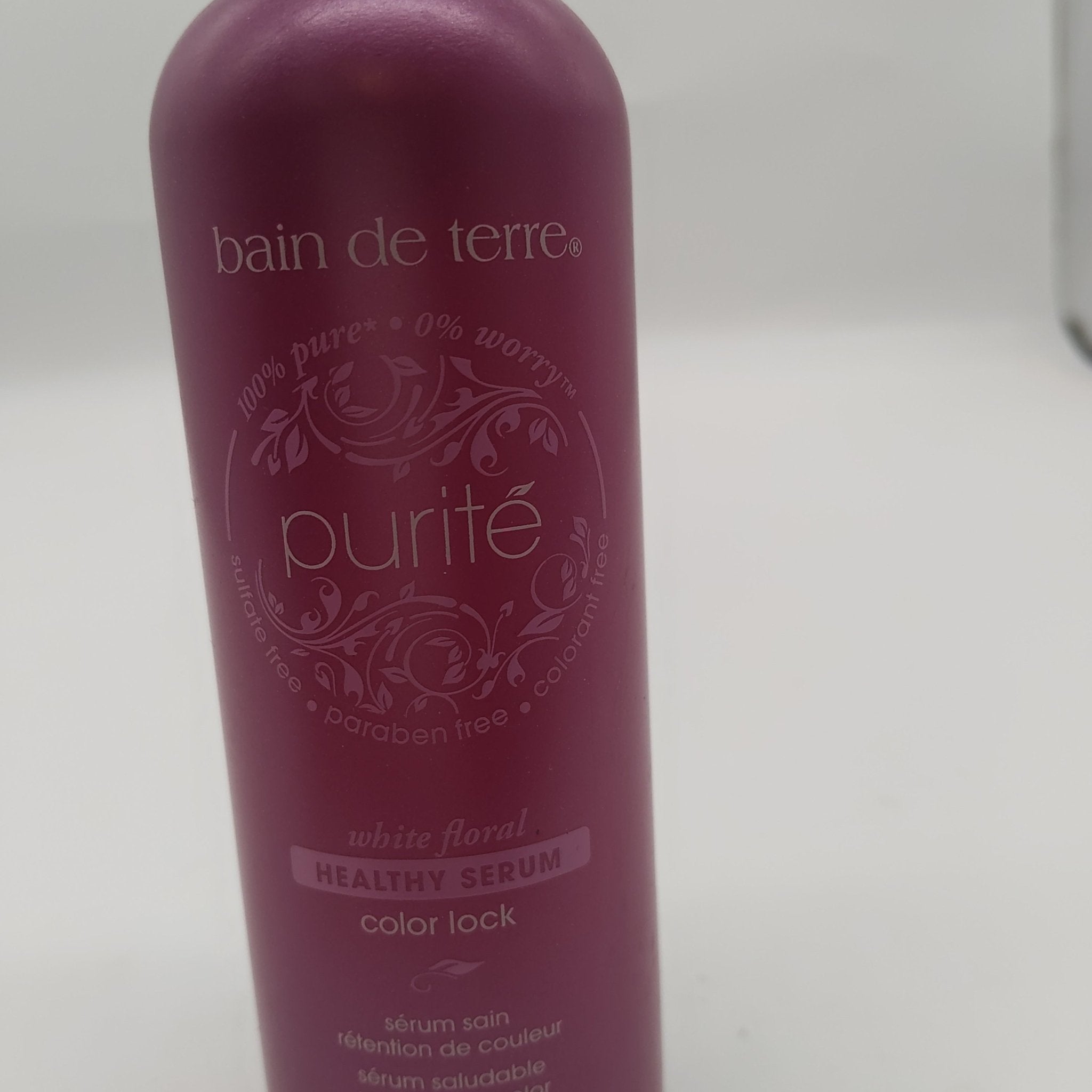 Deep magenta bottle of Bain de Terre Purite Healthy Serum Color Lock 4.2 fl oz