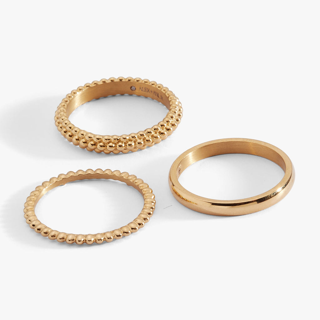 Set of three stacking rings featuring smooth, ball-textured, and domed band designs in a metallic finish.