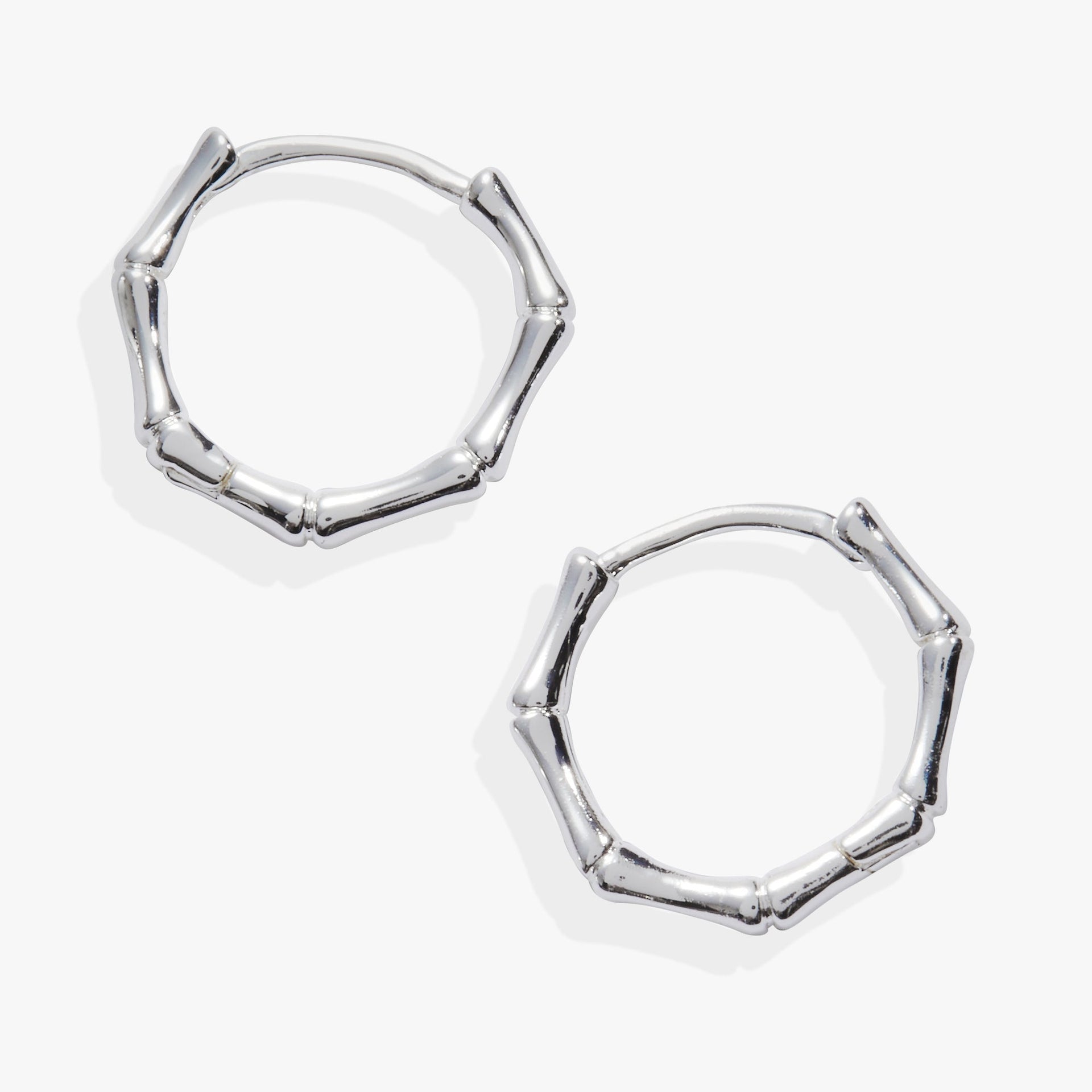 A pair of gold-toned Bamboo Huggie Hoop earrings featuring sculptural bamboo-inspired textures and small faceted crystals.