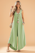 Model wearing a sage green sleeveless V-neck jumpsuit with wide legs and side pockets
