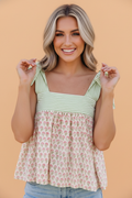 Model wearing a Floral Stripe Babydoll Tank Top with knot-tie straps and a gathered neckline