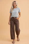 Model wearing Solid Denim Patch Pocket Barrel Leg Jeans with a relaxed fit and square back pockets.