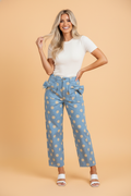 Polka dot denim barrel leg jeans with bow pocket details, styled for a casual look