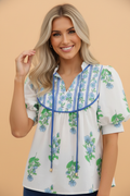 Pretty Bash floral blouse featuring tie neck detail and voluminous puff sleeves in a relaxed tunic silhouette.