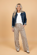 Woman wearing high-waisted brown and white gingham plaid wide-leg shift pants in a casual setting