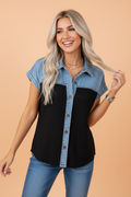 Woman wearing a colorblock denim and black waffle knit patchwork button-down shirt.
