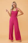 Pretty Bash sleeveless wide-leg jumpsuit with a smocked square-neck bodice in vibrant magenta and teal colors.