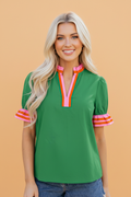 A vibrant striped blouse with a frilled collar and ruffled short sleeves in green, blue, pink, and orange.