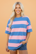 An oversize tunic tee with a striped colorblock design in blue and pink, styled for a casual look.