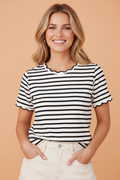A woman wearing a classic black and white striped knit t-shirt with a delicate scalloped round neckline.